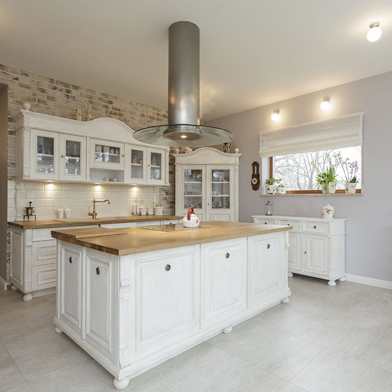 Open kitchen remodel with a large island, glass-front upper cabinets and tile backsplash